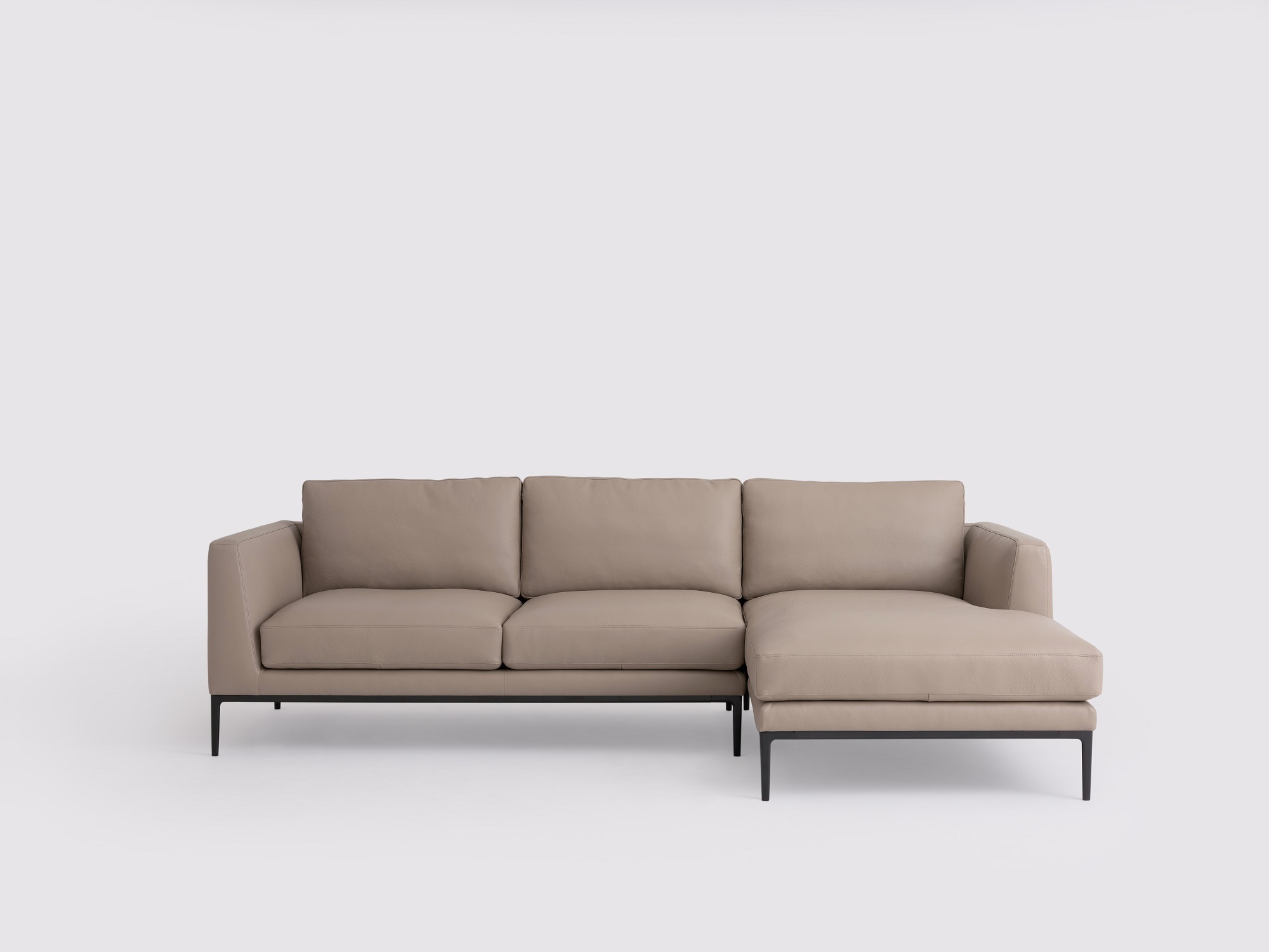 Front view of the Oma modern sectional couch in grey leather with right hand chaise